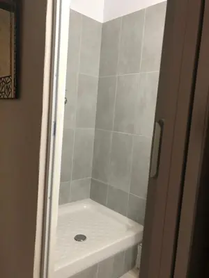 a shower with a white tub in a bathroom at Villa Thermopilon in Larnaka