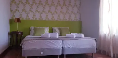a bedroom with a bed with a green wall at Villa Thermopilon in Larnaka