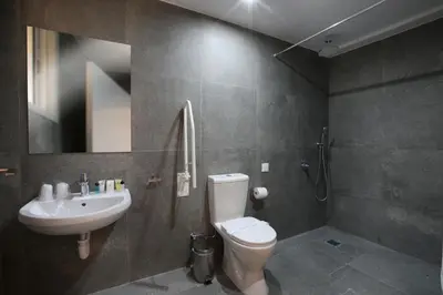 a bathroom with a toilet and a sink at Centrum Hotel - City Center in Nicosia