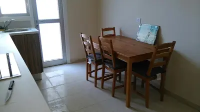 a dining room table and chairs in a kitchen at Modern City Center Apt in Larnaka