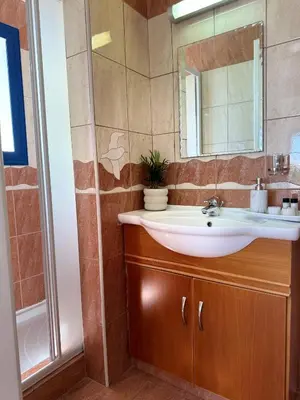 a bathroom with a sink and a mirror at Villa Jenny in Protaras