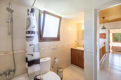 a bathroom with a toilet and a shower in it at The River House in Trimiklini