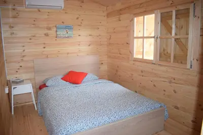 a bedroom with a bed in a wooden room at Cyprus Glamping Park in Ayios Theodhoros