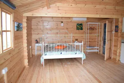 a room with a bed in a log cabin at Cyprus Glamping Park in Ayios Theodhoros