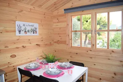 a dining room with a table and a window at Cyprus Glamping Park in Ayios Theodhoros