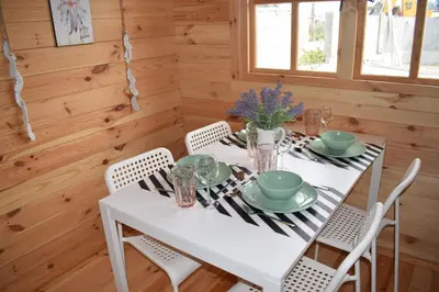 a dining room with a white table and chairs at Cyprus Glamping Park in Ayios Theodhoros