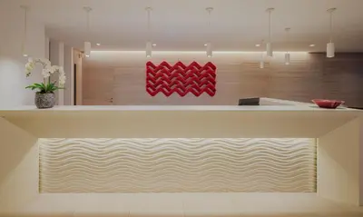 a kitchen with a counter with a red painting on the wall at Tasia Maris Sands (Adults Only) in Ayia Napa