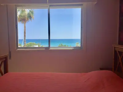 a bedroom with a window with a view of the ocean at Sea View Apartment in Limassol