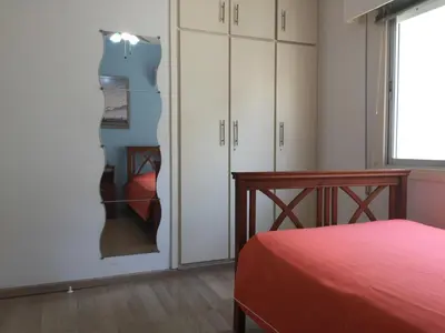 a bedroom with a bed and a glass wall at Sea View Apartment in Limassol