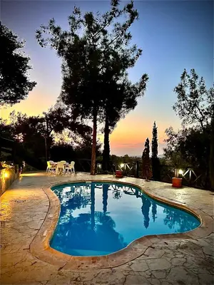 a swimming pool with a sunset in the background at Anti Onirou in Flasou