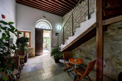 a room with a table and chairs and a staircase at Alkisti City Hotel in Larnaka