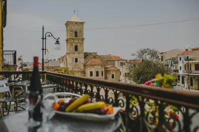 a plate of fruit on a table on a balcony at Alkisti City Hotel in Larnaka