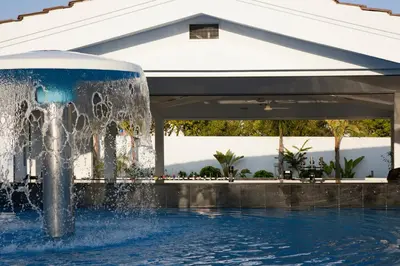 a fountain in the middle of a swimming pool at Christofinia Hotel in Ayia Napa