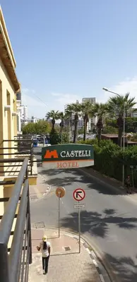 a teddy bear standing on a street with a sign at Castelli Hotel Nicosia in Nicosia