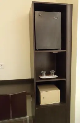 a entertainment center with a television and a box at Castelli Hotel Nicosia in Nicosia