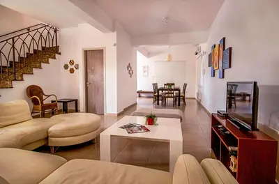 a living room with a couch and a tv at Nissi Villa Gintare in Ayia Napa
