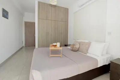 a bedroom with a bed with a table on it at Nissi Villa Christa in Ayia Napa