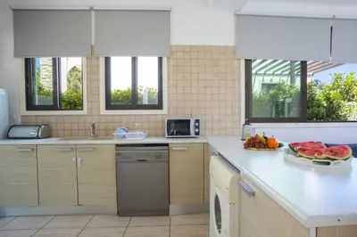 a kitchen with a plate of fruit on a counter at Villa Mylos 7 in Protaras