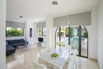 a living room with a white table and chairs at Villa Mylos 7 in Protaras