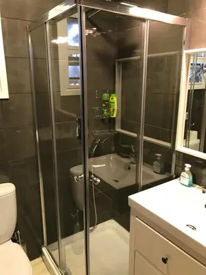 a bathroom with a shower with a toilet and a sink at Luxury Studio Ayia Napa Center in Ayia Napa