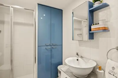a bathroom with a sink and a shower at Lazuli Sea View Beachfront Ap 254 in Larnaka