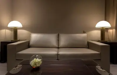 a living room with a couch and two lamps at Amarande (Adults Only) in Ayia Napa