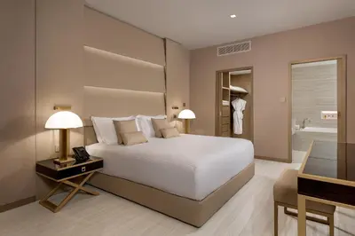 a bedroom with a white bed and a bathroom at Amarande (Adults Only) in Ayia Napa