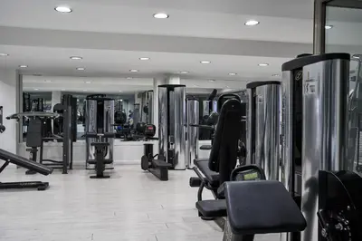 a gym with lots of treadmills and machines at Atlantica Oasis Hotel in Limassol