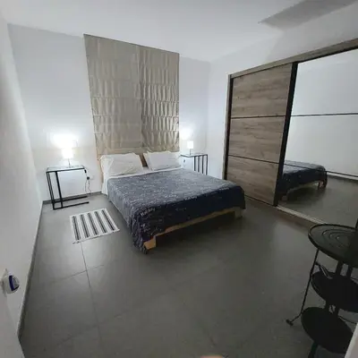 a bedroom with a bed and a dresser at Julia's Residence in Nicosia