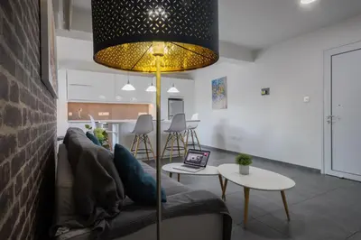 a living room with a couch and a table at Poseidon Apartment by Michalis in Ayia Napa