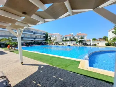 a swimming pool under an umbrella in a resort at Mythical Sands Resort - Antonios in Paralimni