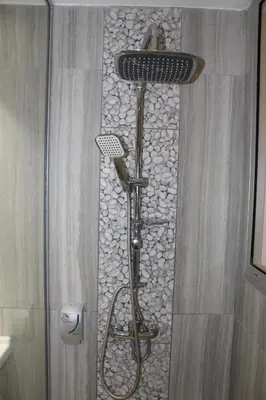a shower with a shower head in a bathroom at Fedrania Gardens Hotel in Ayia Napa