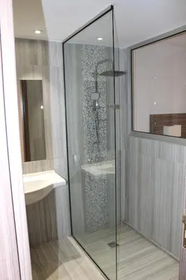 a glass shower in a bathroom with a sink at Fedrania Gardens Hotel in Ayia Napa