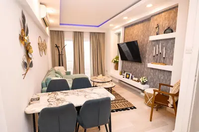 a living room with a table and chairs at Lazuli Sea View Beachfront Ap 21 in Larnaka