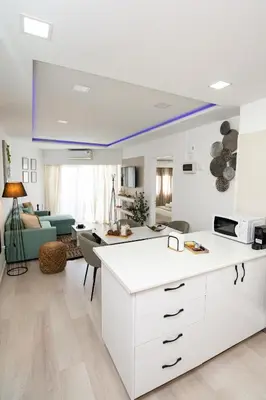 a kitchen and living room with a blue ceiling at Lazuli Beach & Pool Apartment 501 in Larnaka