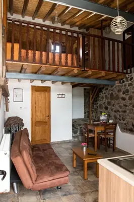 a living room with a couch and a table at AgroSpito Traditional Guest House in Agros
