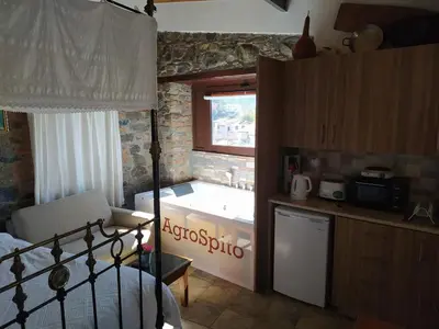 a kitchen with a bath tub in a room at AgroSpito Traditional Guest House in Agros