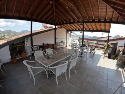 a dining room with a table and chairs on a patio at AgroSpito Traditional Guest House in Agros