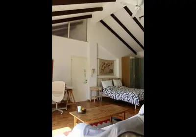 a room with two beds and a table in it at Studio Room Ensuite by the Beach, Entire Independent Unit in Limassol