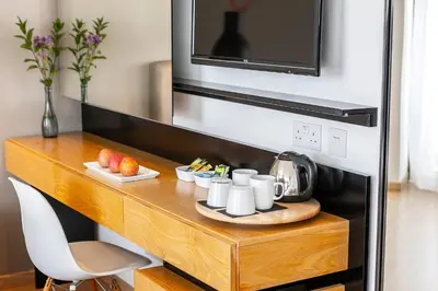 a table with cups and plates of food and a microwave at Crystal Springs Beach Hotel in Protaras