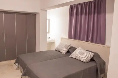 a bedroom with a bed with two pillows on it at Makronissos Beach Studio in Ayia Napa