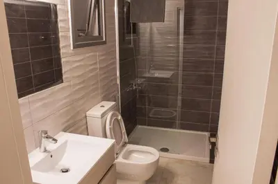 a bathroom with a toilet and a sink and a shower at Makronissos Beach Studio in Ayia Napa