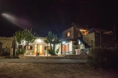 a house at night with its lights on at Amalia Panorama House in Zanaja