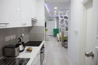 a kitchen with a sink and a counter top at Lazuli Sea View-Beachfront Ap 405 in Larnaka