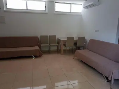 a waiting room with couches and a table and windows at River Apartments in Galata