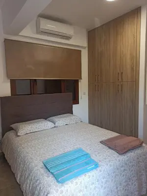 a bedroom with a bed with blue towels on it at River Apartments in Galata