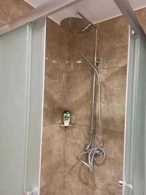 a shower with a shower head in a bathroom at River Apartments in Galata