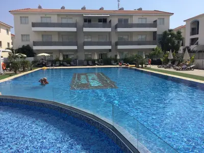 a large swimming pool in front of a building at Apartment Helena in Paralimni