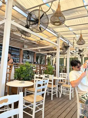 a man sitting at a table in a restaurant at Apartment Helena in Paralimni