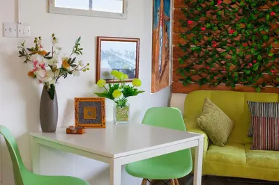 a living room with a table and a yellow couch at Artemis Boutique Apartment 1 in Limassol